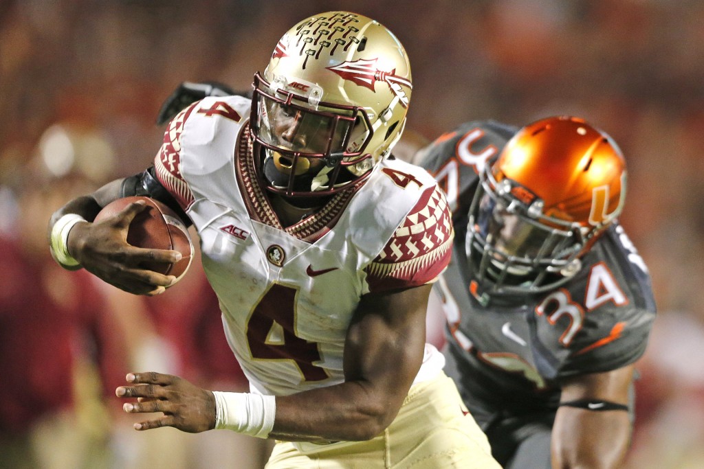 MIAMI GARDENS, FL - NOVEMBER 15: Dalvin Cook #4 of the Florida State Seminoles scores the winning touchdown in the fourth quarter against the Miami Hurricanes on November 15, 2014 at Sun Life Stadium in Miami Gardens, Florida. The Seminoles defeated the Hurricanes 30-26. (Photo by Joel Auerbach/Getty Images)